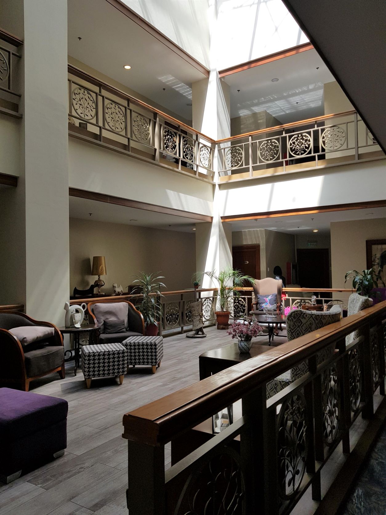 The atrium of a hotel building in the Philippines is illuminated by natural light.