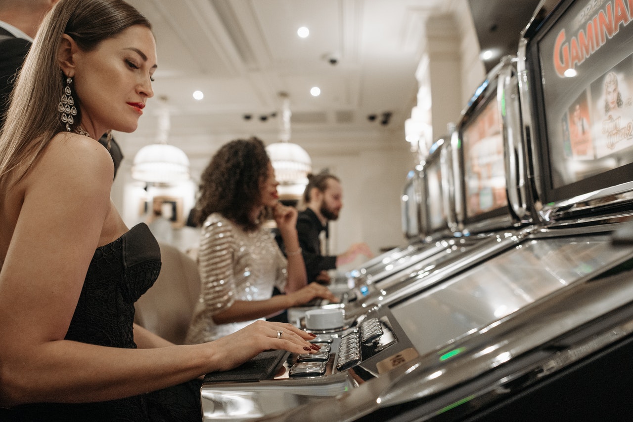 Woman playing with an electronic gaming machine inside an integrated resort development with casino facilities.