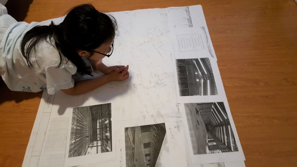 Young architect in the Philippines studying the plans for an industrial park.