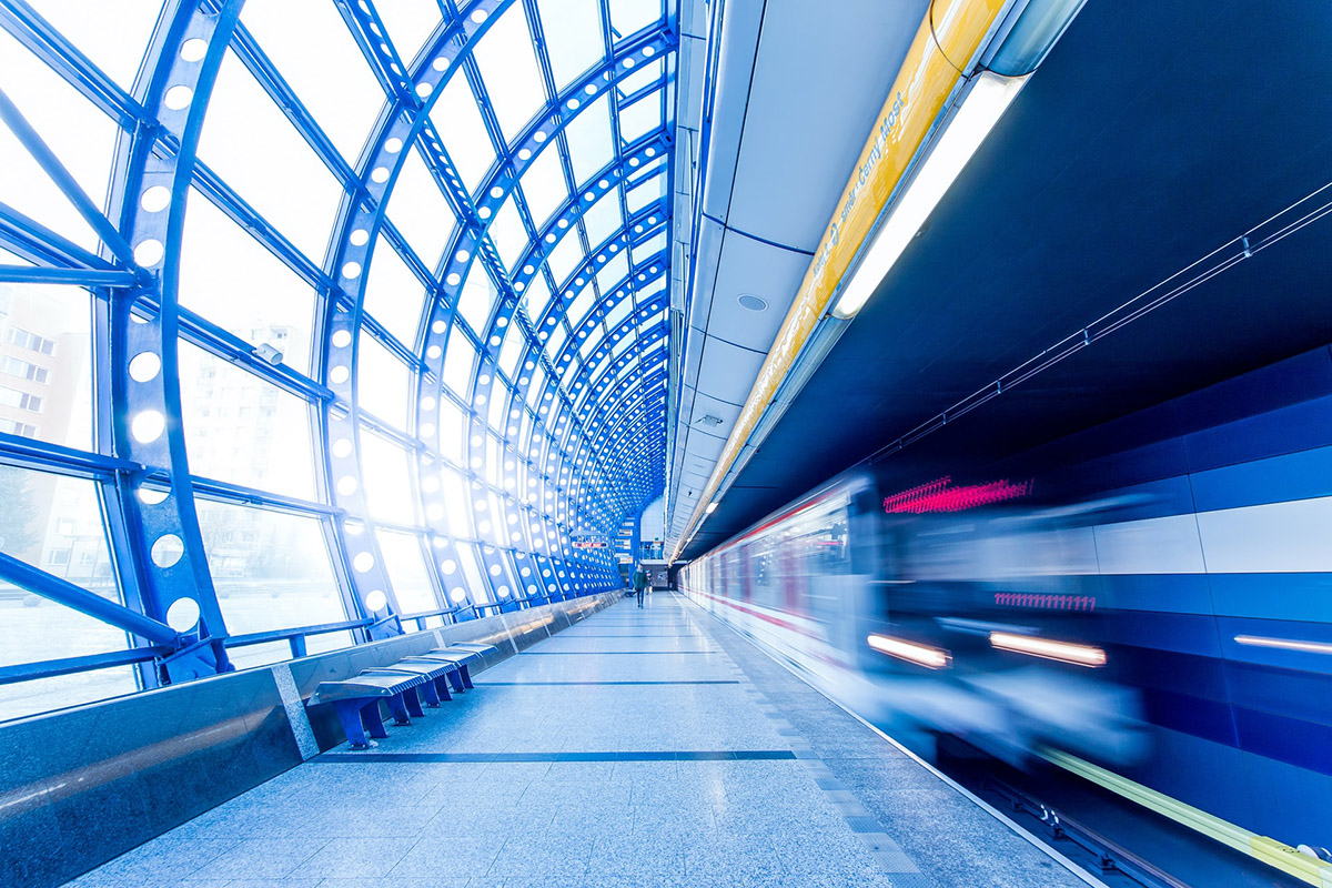 Transportation station platform with passing train and daylight