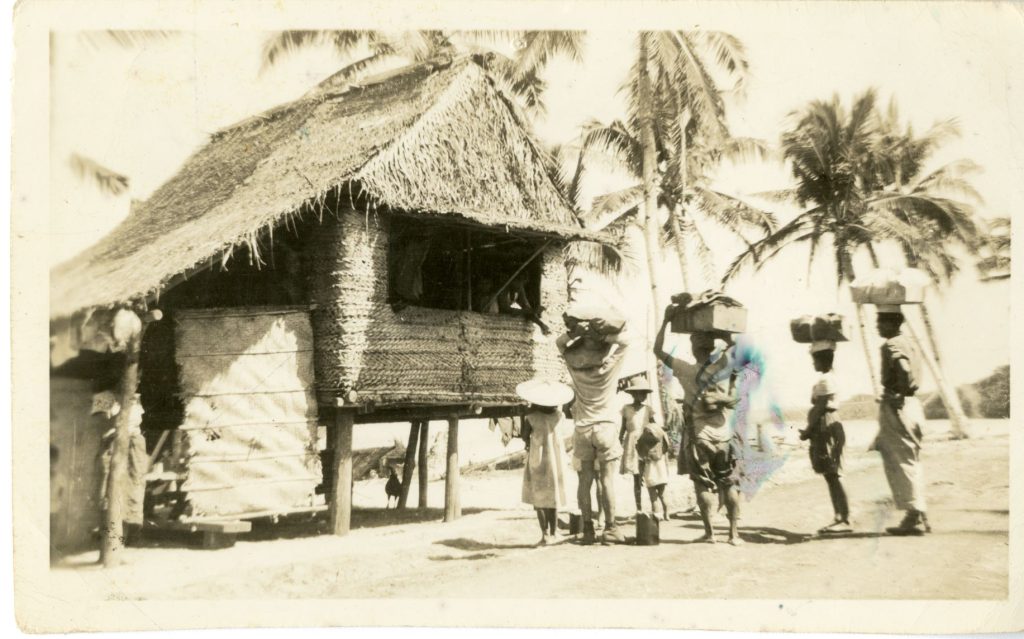 Old photo of a Bahay Kubo in the philippines built on stilts and raised flooring with tatched roof