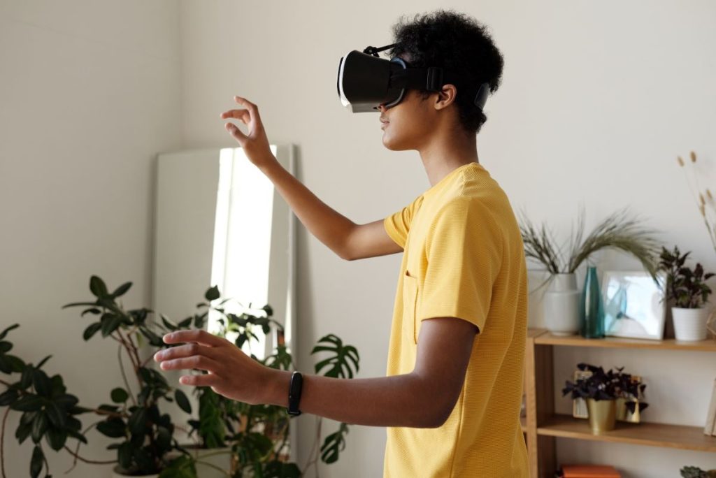 A young architect immerses themselves in a virtual reality (VR) environment, using a headset to collaborate on a Building Information Modeling (BIM) project enhanced by artificial intelligence (AI)