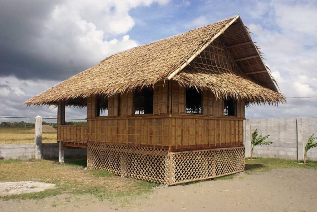 A stilted Bahay Kubo with a generous roof form, exemplifying early sustainable practices in Filipino architecture.