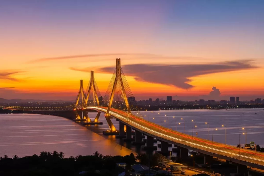 A long cable-stayed bridge stretches across a wide expanse of water, connecting two urbanized shorelines under a bright sky, symbolizing enhanced infrastructure and real estate investment opportunities in the Philippines.