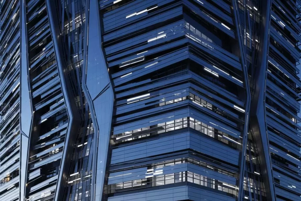 A conceptual rendering of a futuristic kinetic building featuring modular panels with embedded sensors and moving components, illustrating meta-builders in adaptive architecture through dynamic façades and intelligent structural systems.