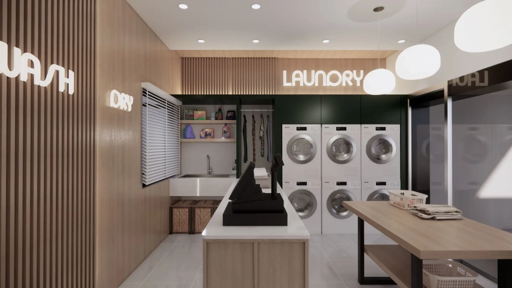 Modern interior view of a laundry shop with wood-accented walls, cash register counter, built-in washing and drying machines, folding table, pendant lighting, and functional storage shelves