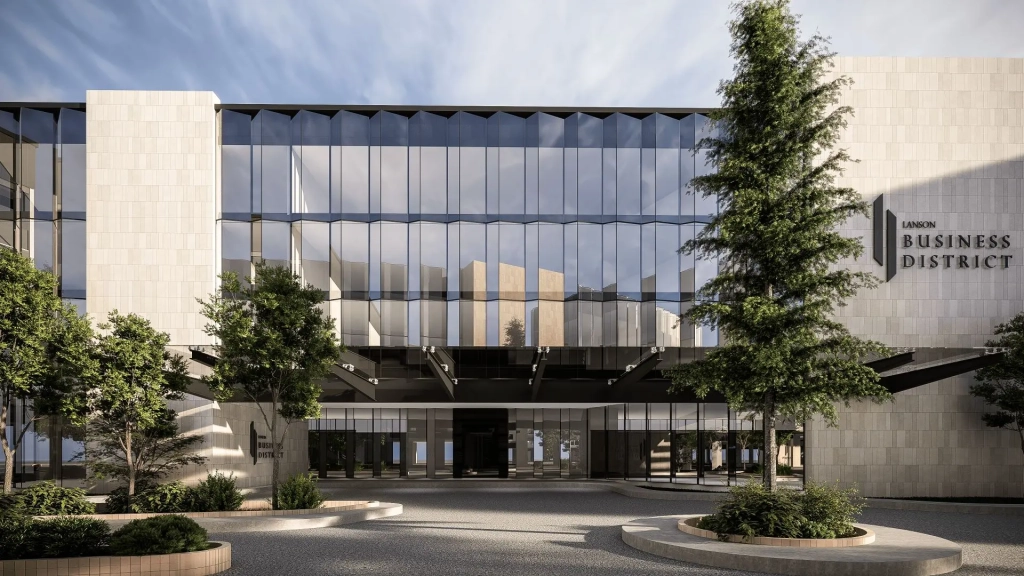 Lanson Integrated Estate business district showing stone-clad office building, full-height glass façade, landscaped forecourt, and pedestrian plaza within mixed-use development.