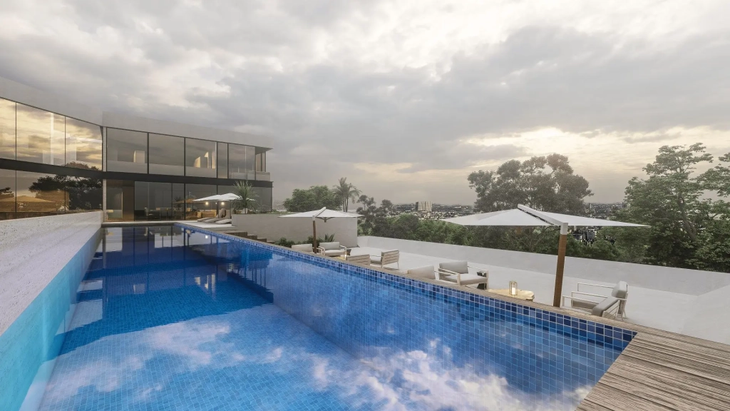 Luxury residence outdoor pool deck with linear swimming pool, blue tiled basin, wood deck border, outdoor seating clusters with white umbrellas, panoramic views of treetops and city skyline, modern glass façade backdrop, sunset sky reflections