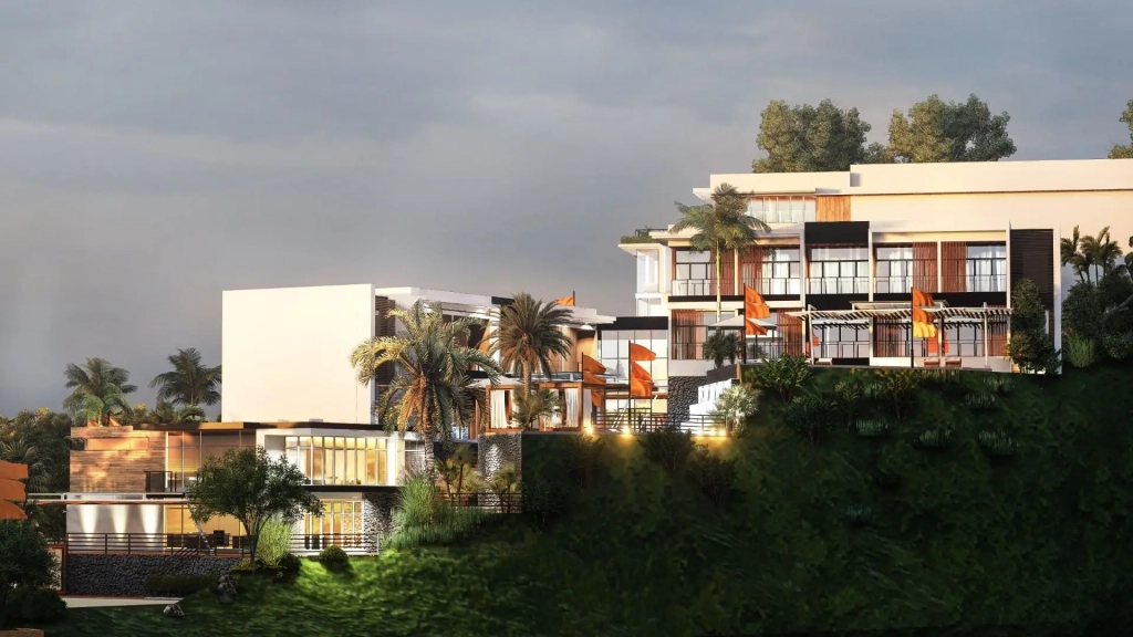 Cliffside hotel development featuring tiered white buildings with wood and glass accents, private balconies with orange sunshades, stone retaining walls, landscaped terraces, and panoramic views of the ocean and Corregidor Islands, framed by palm trees and dense greenery.