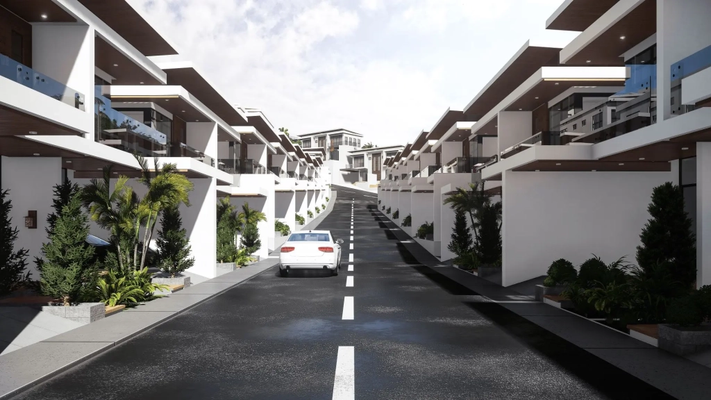 Elevated street perspective of modern townhomes with white facade walls, wide cantilevered balconies, glass railings, deep roof overhangs, open carports, landscaped planters with tropical trees and shrubs, asphalt road with centerline, and ascending site grading leading toward community clubhouse.