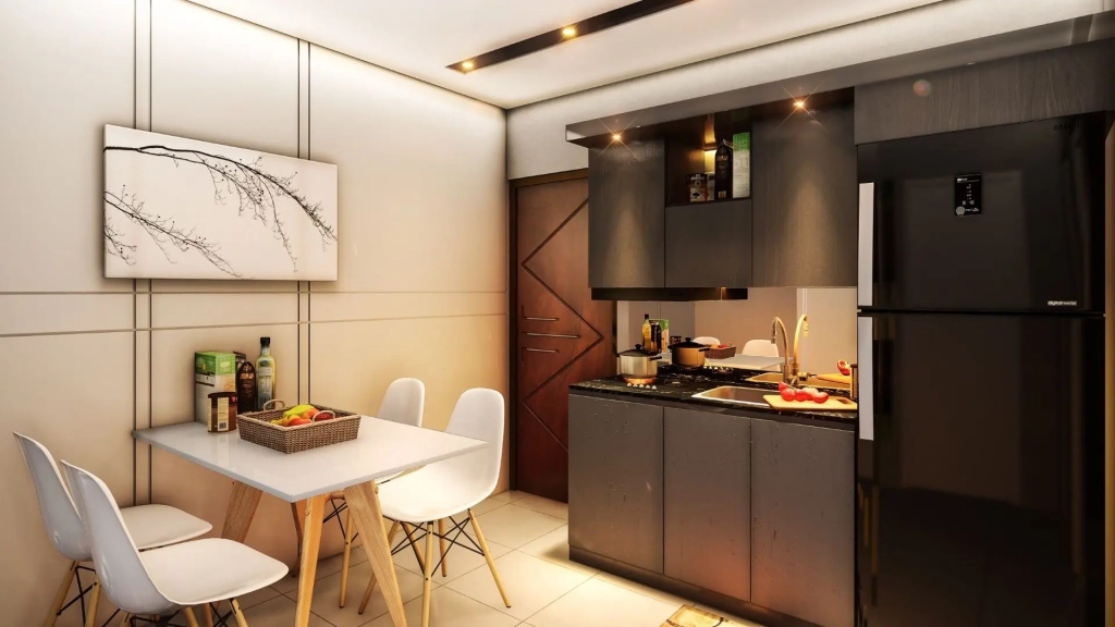 Compact studio apartment kitchen with dark wood cabinetry, integrated appliances, solid surface countertop, adjacent dining area with white chairs and wooden table, neutral wall finishes, and warm ambient lighting.